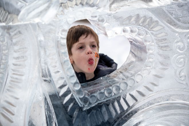 Four-year-old Leland Homolek of Plymouth checks out the ice carvings during the Plymouth Ice Festival in Plymouth, February 5, 2023.