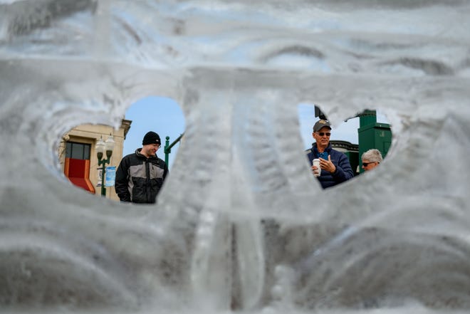 Visitors check out the ice carvings during the Plymouth Ice Festival, in Plymouth, February 5, 2023.