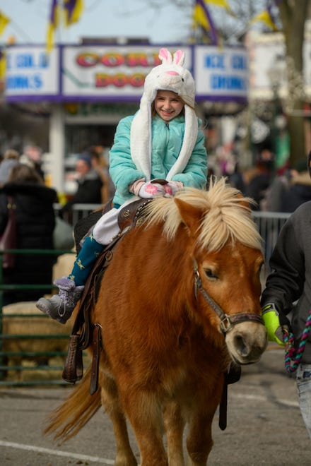 Six-year-old Madeline Skinner of Fenton rides a pony during the Plymouth Ice Festival in Plymouth, February 5, 2023.