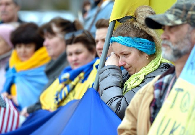 Sofiia Koval of Warren, who was born in Ukraine, wipes tears from her eyes near the end of a rally in support of the war-torn country on Wednesday, March 16, 2022, in Warren.