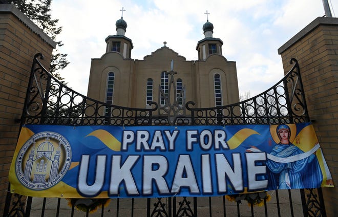 A banner requesting the public to Pray For Ukraine has been displayed for a year now, since the war began, as seen, Thursday night, Feb. 23, 2023, in front of Southfield's St. Mary the Protectress Ukrainian Orthodox Cathedral  Thursday night, Feb. 23, 2023, as the church prepares for a pray-service service, Friday night, on the one-year anniversary of Russia invading Ukraine.