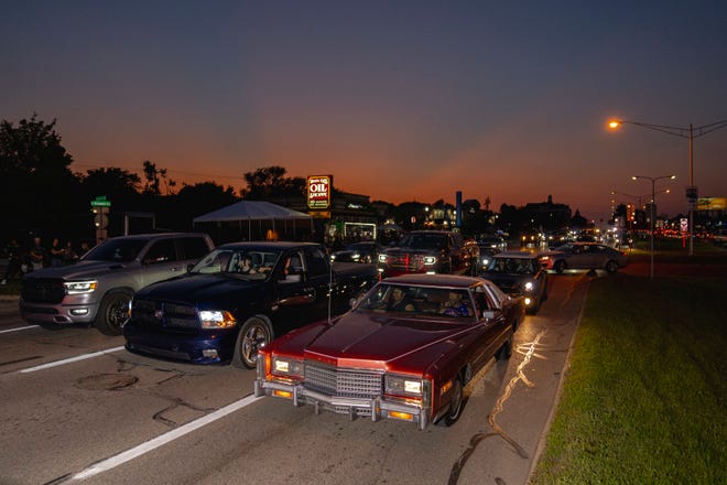 Cars cruise by during the Woodward Dream Cruise along Woodward Avenue in Royal Oak, Mich. on Aug. 19, 2023.